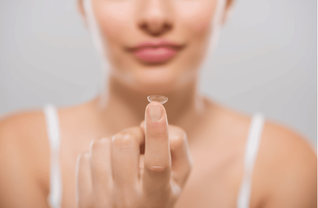 Tips for Taking Care of Your Contact Lenses 1 Focus on contact lens on finger of young woman.