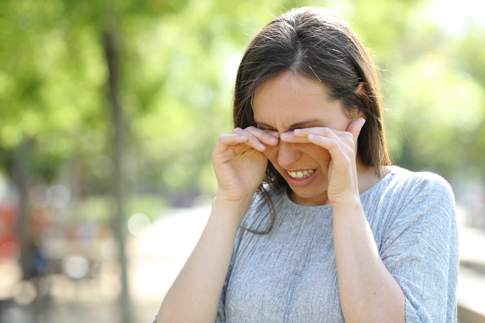 How Punctal Plugs Can Help with Dry Eye 1 Woman outdoors rubbing eyes due to dry eye in Chesapeake, VA