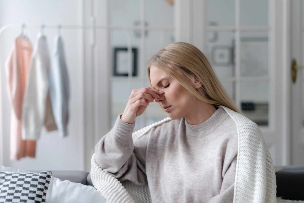 What Are the Symptoms of an Ocular Migraine? 1 A woman pinching the bridge of her nose because she has an ocular migraine