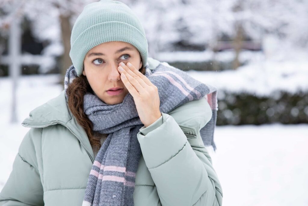 Got Dry Eyes This Winter? Here’s How TearLab® Dry Eye Testing Can Help 1 Young woman, bundled up in a heavy winter coat and hat, rubs her dry eyes