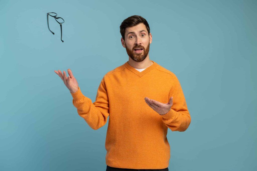 When Will I See Clearly After LASIK? A Timeline for Recovery 1 Man tossing glasses because he can see clearly after LASIK eye surgery