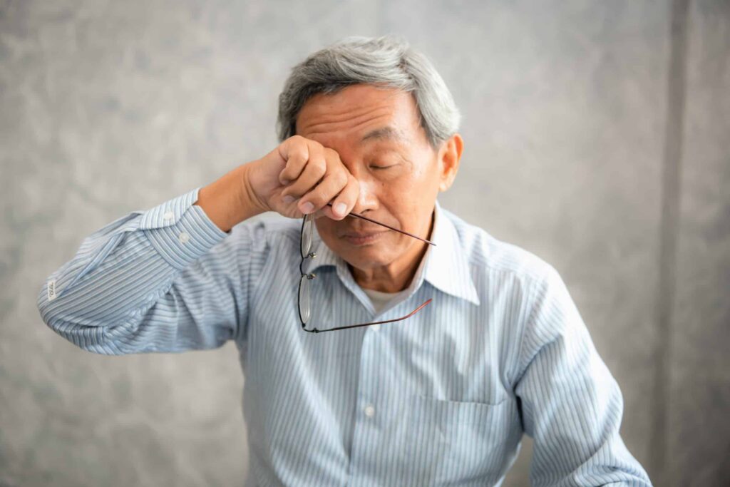 Blepharitis vs. Dry Eye: How to Tell the Difference 1 Man rubbing his eyes due to symptoms of blepharitis or dry eye in Chesapeake, VA