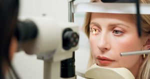 Woman getting a comprehensive eye exam in Chesapeake, VA
